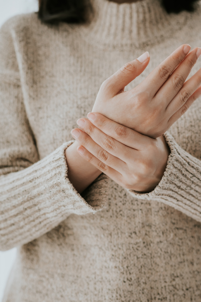 Woman experiencing wrist pain from her office job. Chiropractic care at Simpsonville Chiropractic Solutions can help alleviate pain and improve hand and wrist function.