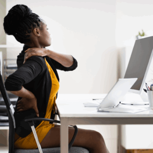 a women stretching while sitting at a desk